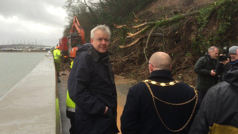 Carwyn Jones with Beaumaris mayor Jason Zalot on the road between Beaumaris and Menai Bridge where there has been a landslip