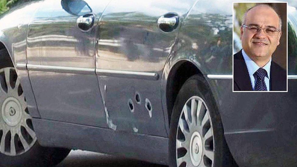 Car of national park director Giuseppe Antoci with bullet holes, with an inset picture of Mr Antoci;