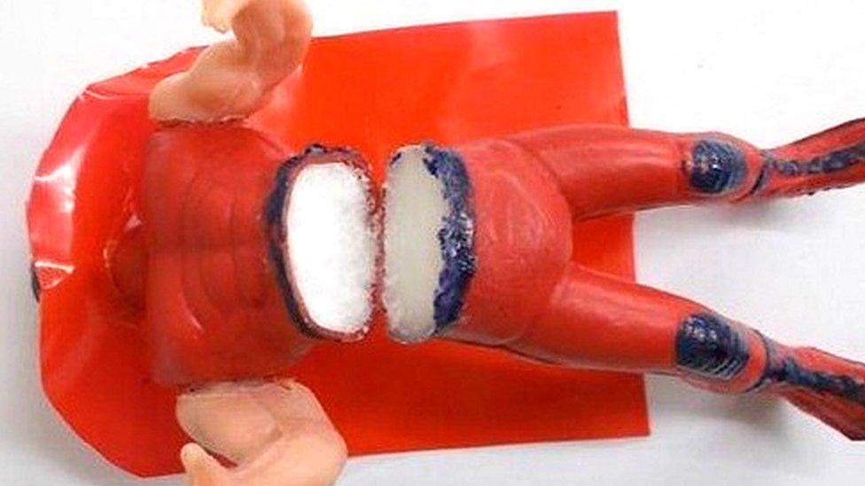 One of the toy figures cut open to reveal the crystal meth inside