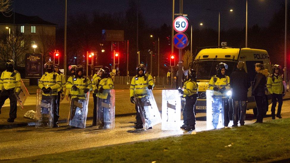 Riot police outside Suites Hotel in Knowsley