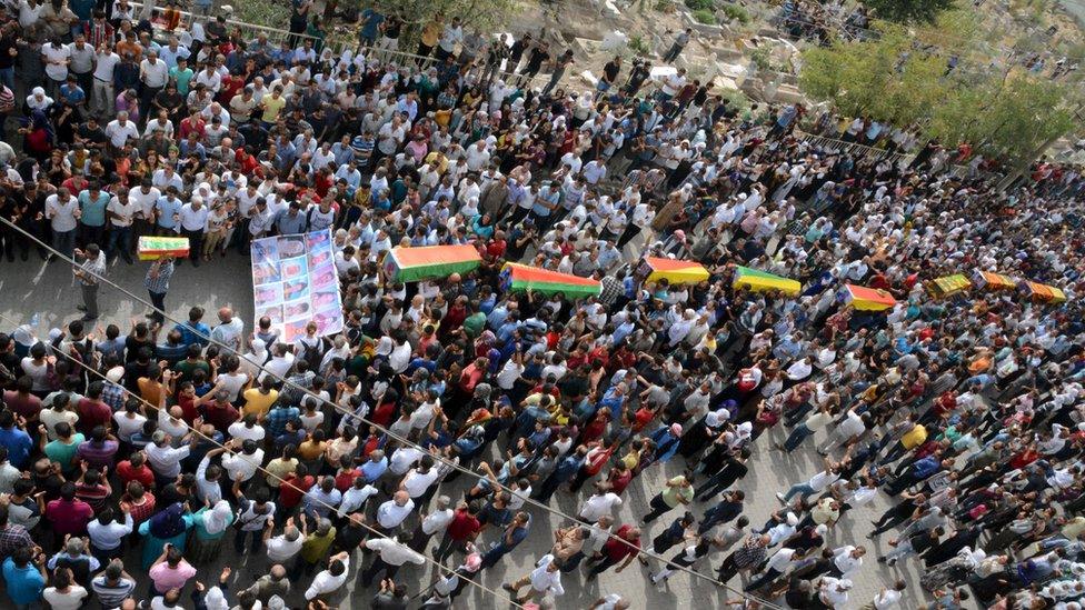 Residents carry coffins of people killed during clashes in Cizre. 13 September 2015