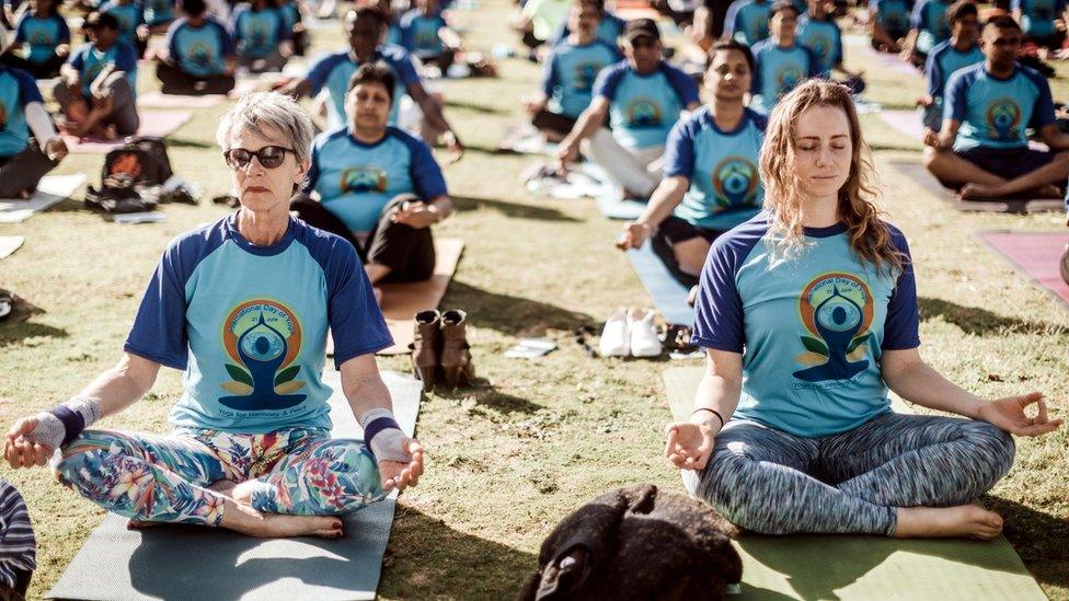 Hundreds of people take part in a yoga session at North Beach on June 17, 2018 in Durban, South Africa, ahead of the International Day of Yoga on June 21.