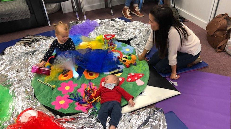 Babies playing on a mat