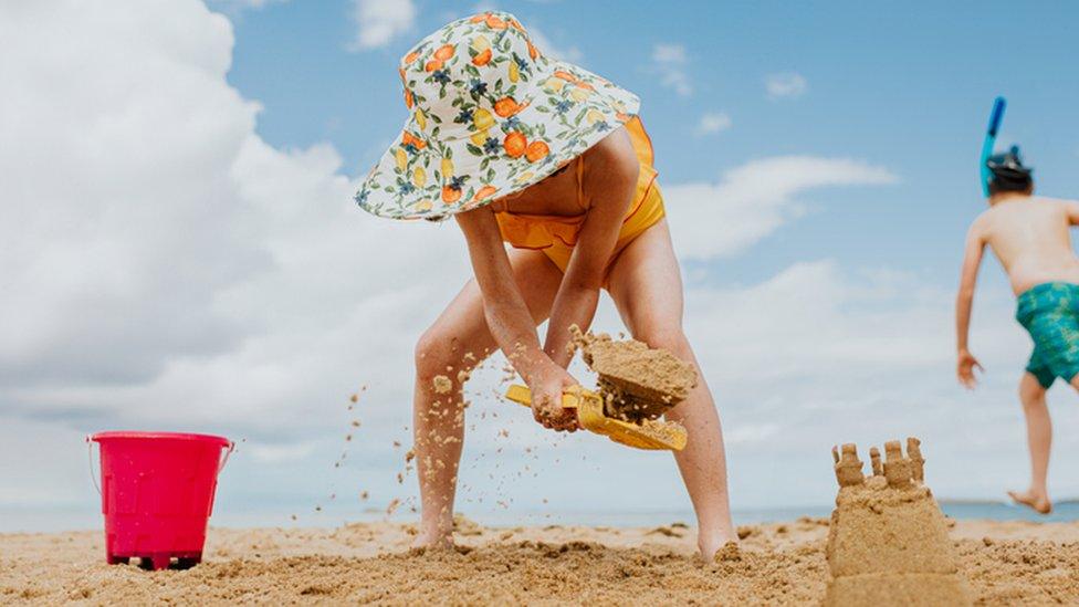 Child making sand castle