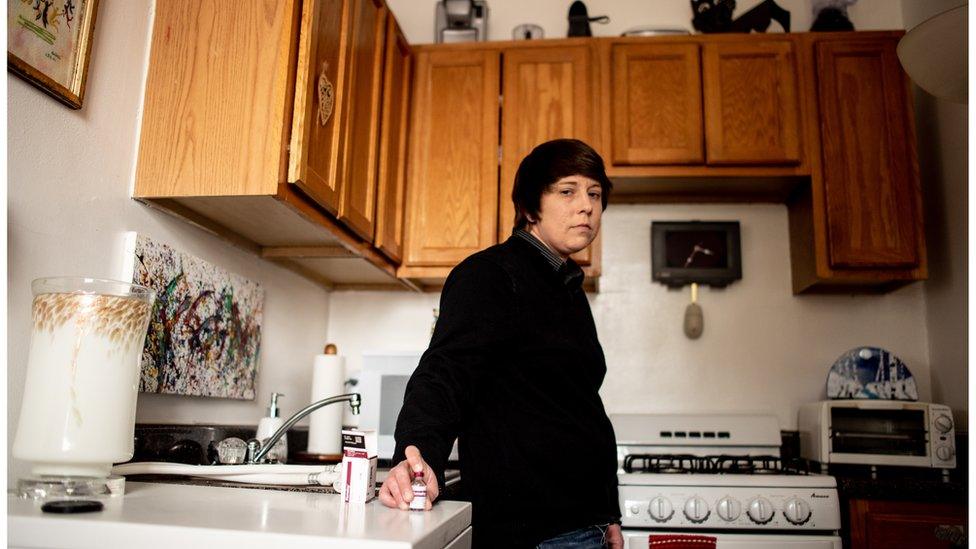 Laura Marston stands in her kitchen, where she stores insulin in a quarter of her fridge