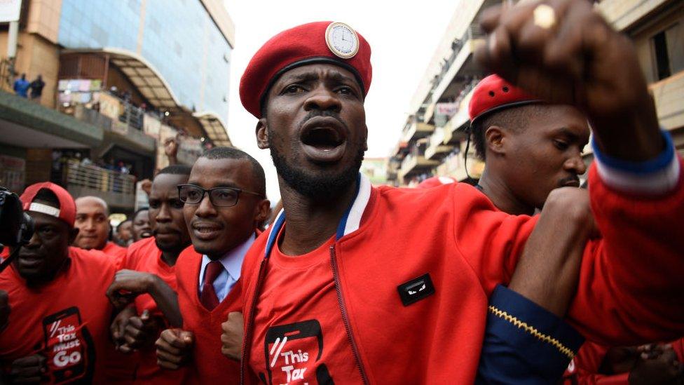 Bobi wine and activist protesting against the social media tax