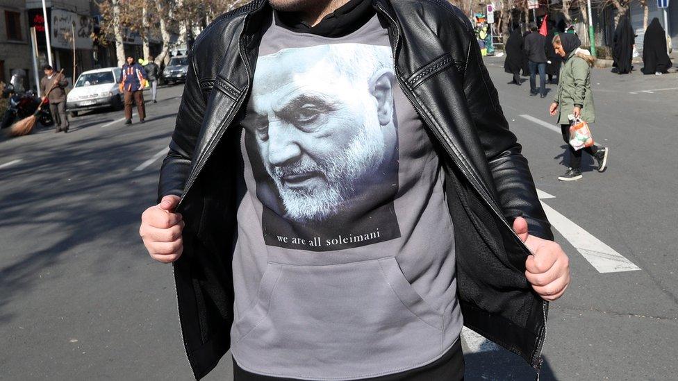 An Iranian boy wears a T-shirt bearing an image of Qasem Soleimani with a slogan reading "we are all Soleimani" during a funeral ceremony in Tehran, 6 January 2020