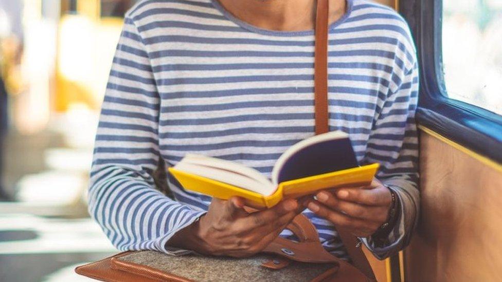 Passenger reading on tram