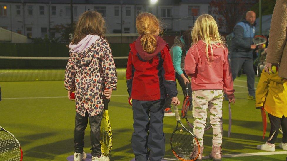 Young girls with tennis racquets