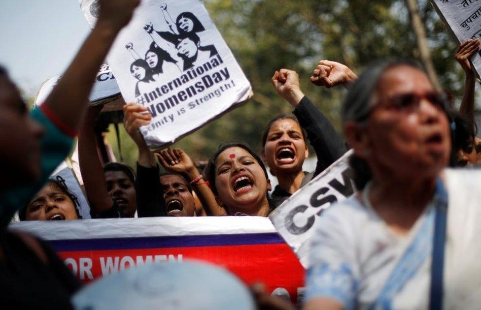 Women shout slogans during a protest demanding equal rights for women in Delhi, India