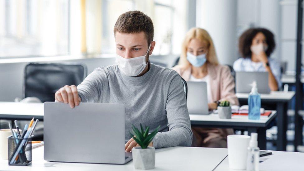 Staff wearing masks in office