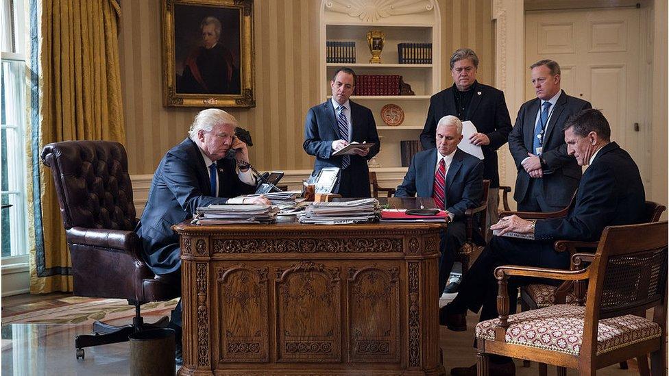 President Donald Trump speaks on the phone with Russian President Vladimir Putin in the Oval Office of the White House, January 28, 2017 in Washington, DC. Also pictured, from left, White House Chief of Staff Reince Priebus, Vice President Mike Pence, White House Chief Strategist Steve Bannon, Press Secretary Sean Spicer and National Security Advisor Michael Flynn.