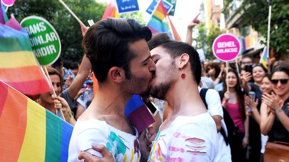 A gay couple kisses during the Gay Pride parade on 28 June 2015 in Istanbul.