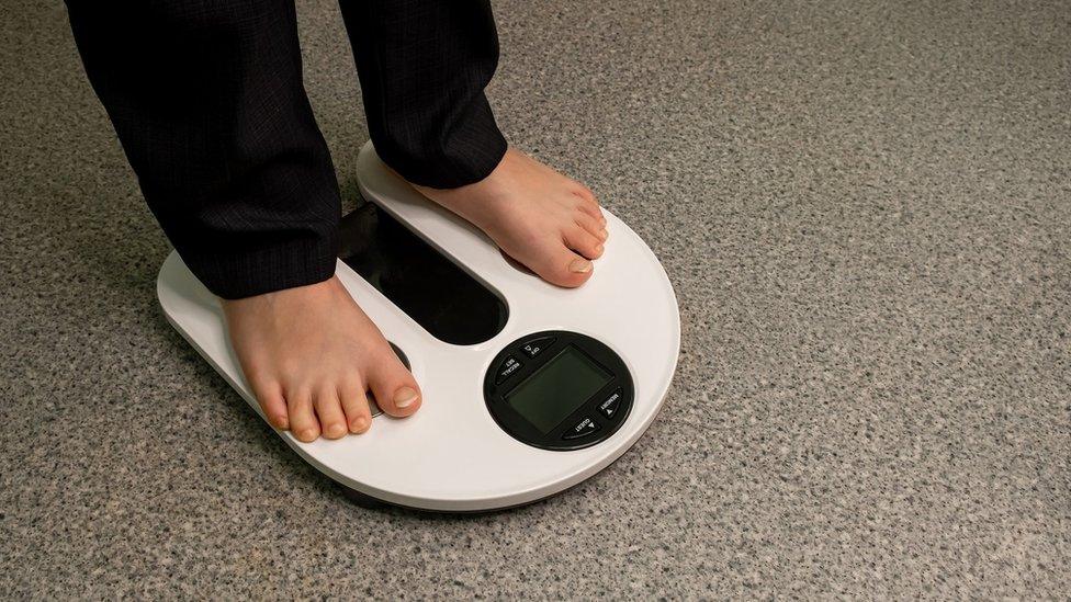 Photo of a child standing on a blank electronic scale