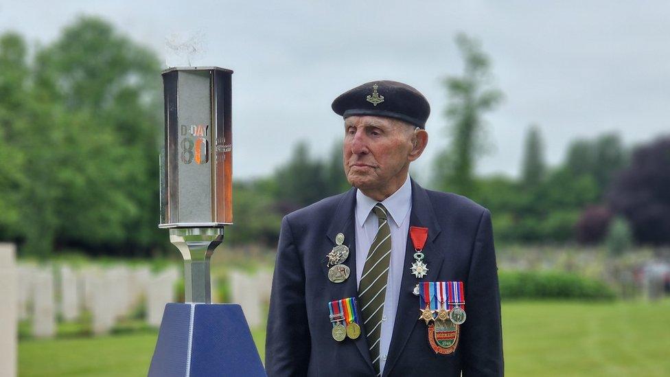 Ken Cooke with the Torch of Commemoration