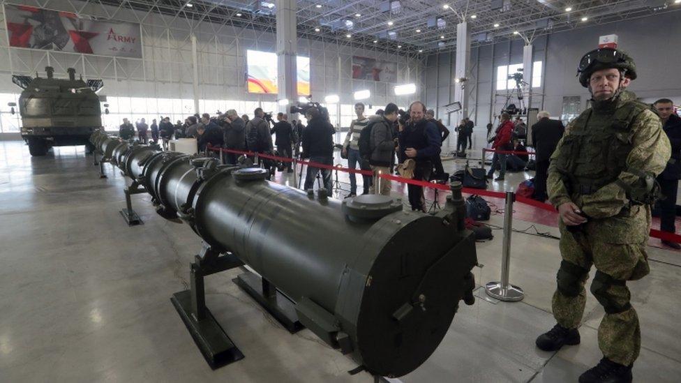 Russian military serviceman stands near the short-range Iskander M missile