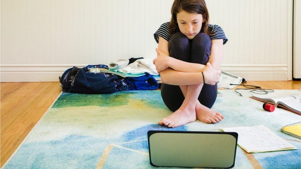 A girl speaking to someone on a tablet computer