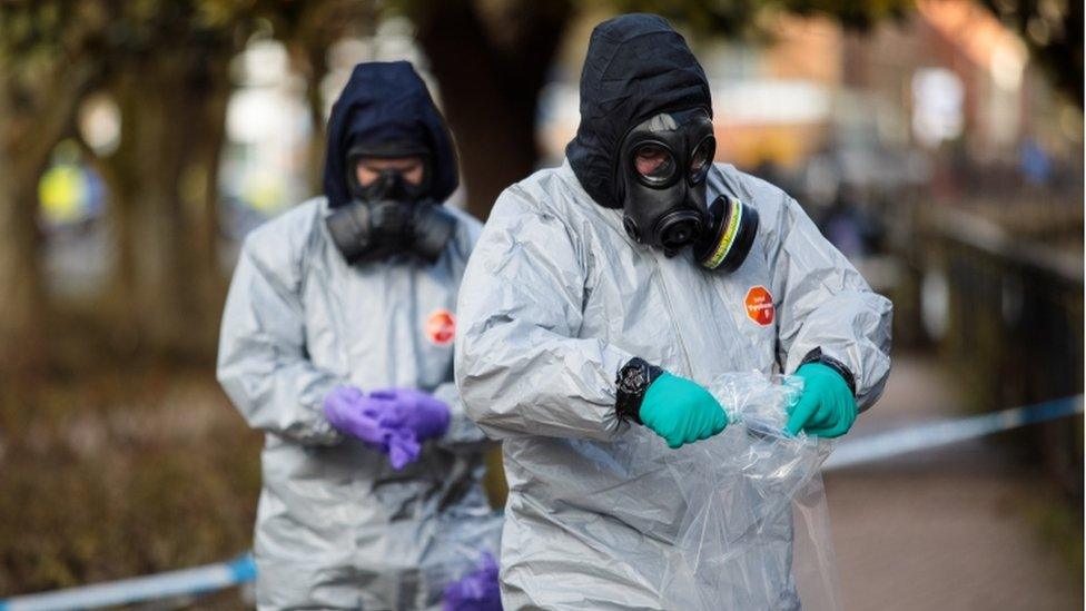 Police officers in protective suits investigate the Skripal poisoning