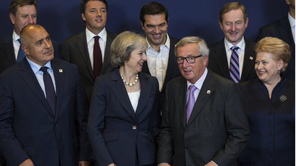 Theresa May alongside Jean-Claude Juncker during the summit group photo