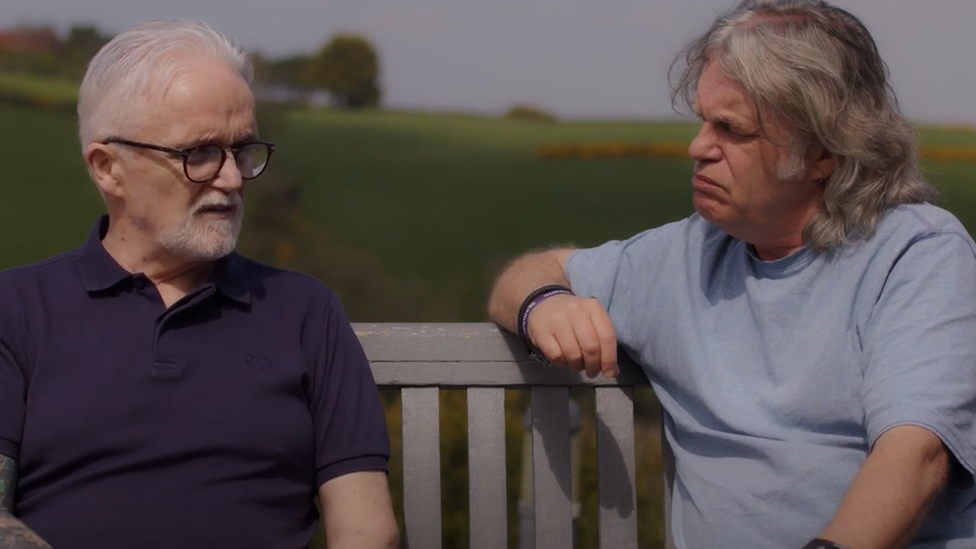 Brothers Gerard and Damian Gorman sitting on park bench