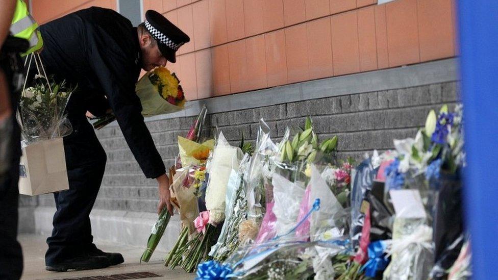 Police officer laying flowers