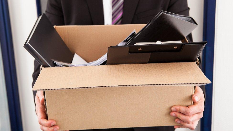 businessman holding cardboard in office