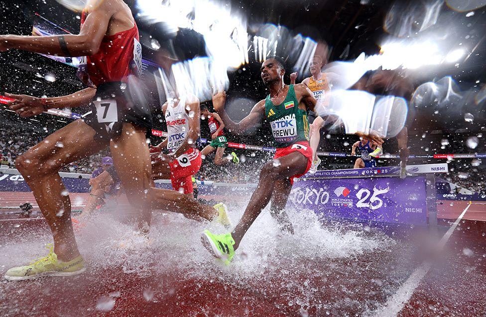 Ethiopia's Samuel Firewu tackles the water jump during the men's 3,000m steeplechase heats at the World Athletics Championships in Tokyo. Photo by Cameron Spencer