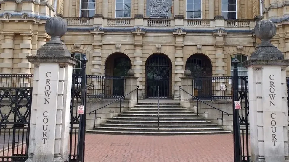 A general view picture of Reading Crown Court, with steps up to the entrance and two large signs with "Crown Court" on both left and right sides