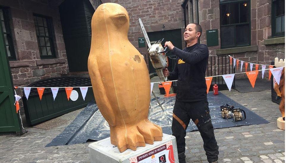 Artist carving his penguin