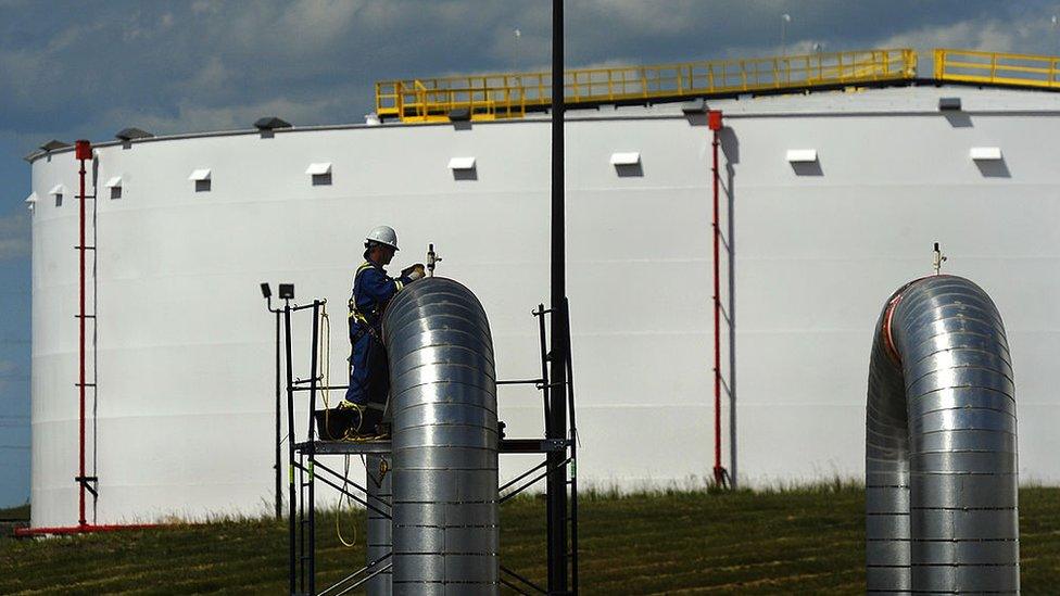 A construction worker works on one of the pumping station outlets at the under construction Hardisty pipeline depot