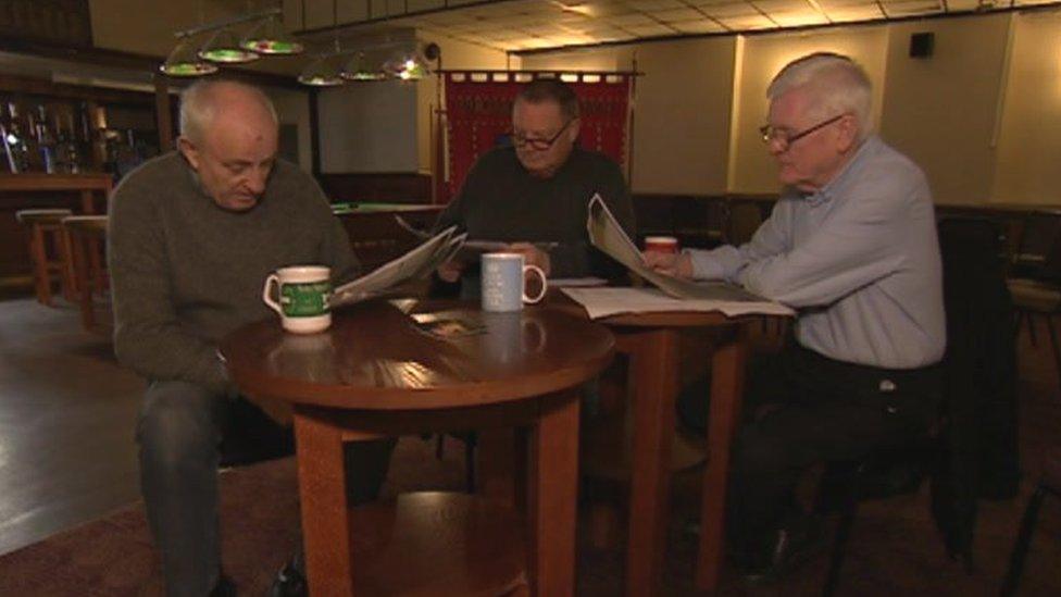 Former miners reading copies of the newly released documents