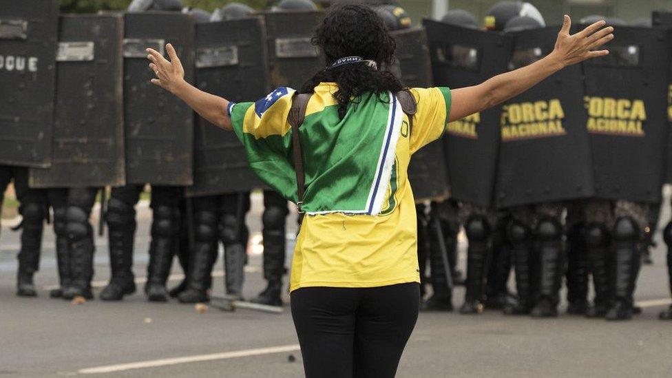 Woman protester facing police