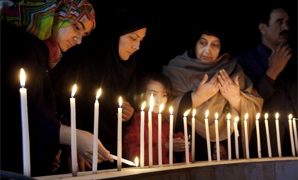 Pakistani women light candles during a vigil for victims of the Bacha Khan University attack, Wednesday, Jan. 20, 2016 in Peshawar, Pakistan