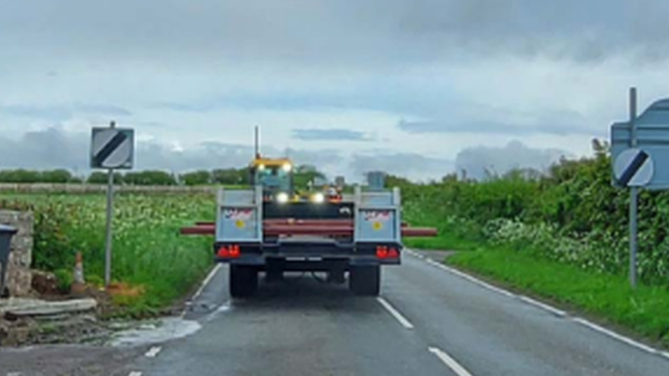 the tractor driving down the road