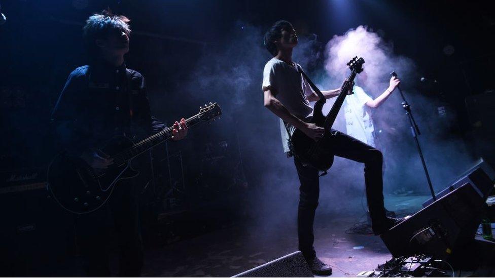 This photo taken on September 17, 2014 shows rock band Bu Ou performing in a bar in Beijing. Beijing has a vibrant rock scene with bands performing at small bars throughout the week.