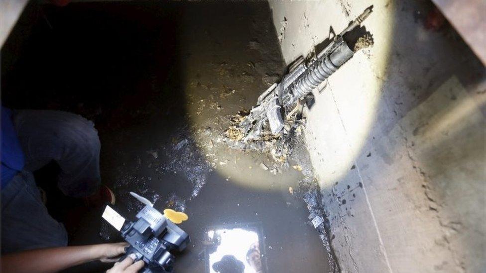 A cameraman films next to a weapon found in a drain from where Joaquin "El Chapo" Guzman escaped