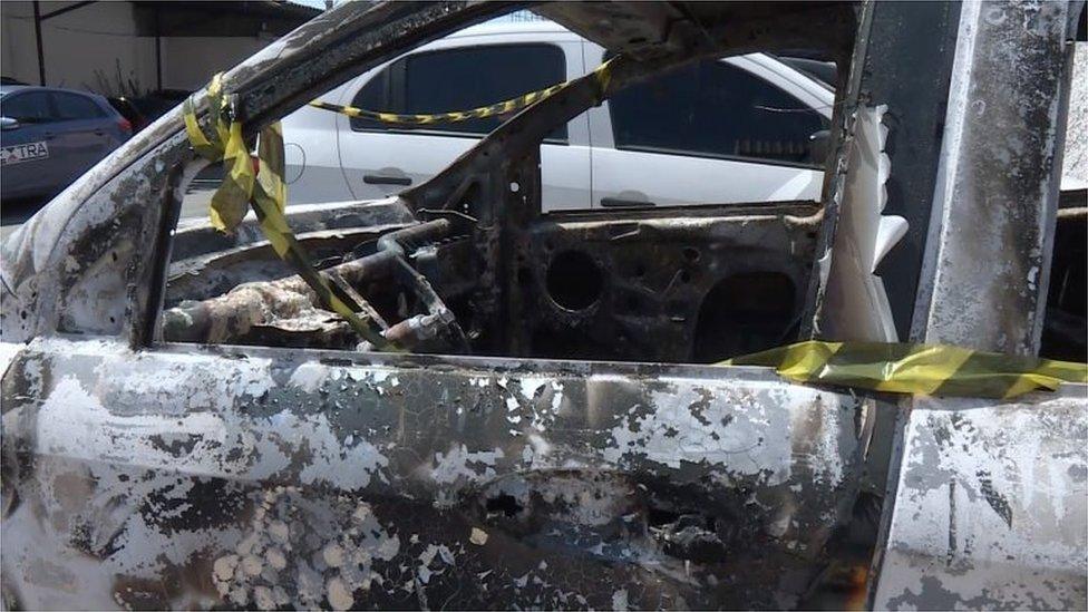 Grab taken from an AFP video showing the burned-out rental car of missing Greek ambassador to Brazil Kyriakos Amiridis, at a parking lot outside the police station in Belford Roxo, in the Brazilian state of Rio de Janeiro, on December 30, 2016, a day after it was found with a body inside.