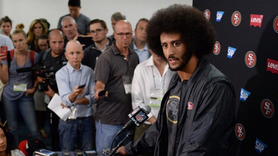 San Francisco 49ers quarterback Colin Kaepernick (right) talks to media after the game against the San Diego Chargers at Qualcomm Stadium