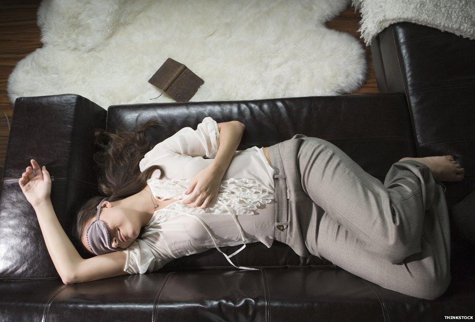 Woman lying on sofa