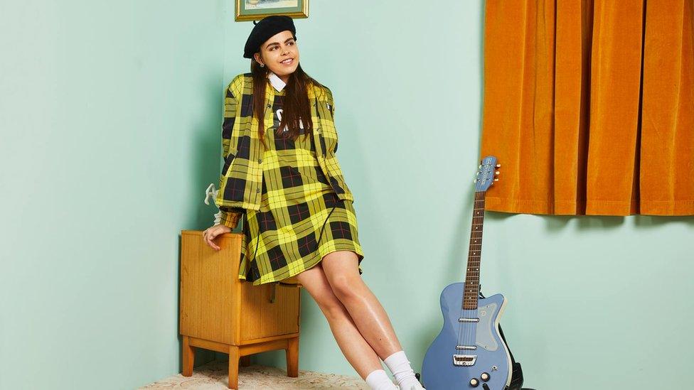 Asos model pictured with a guitar