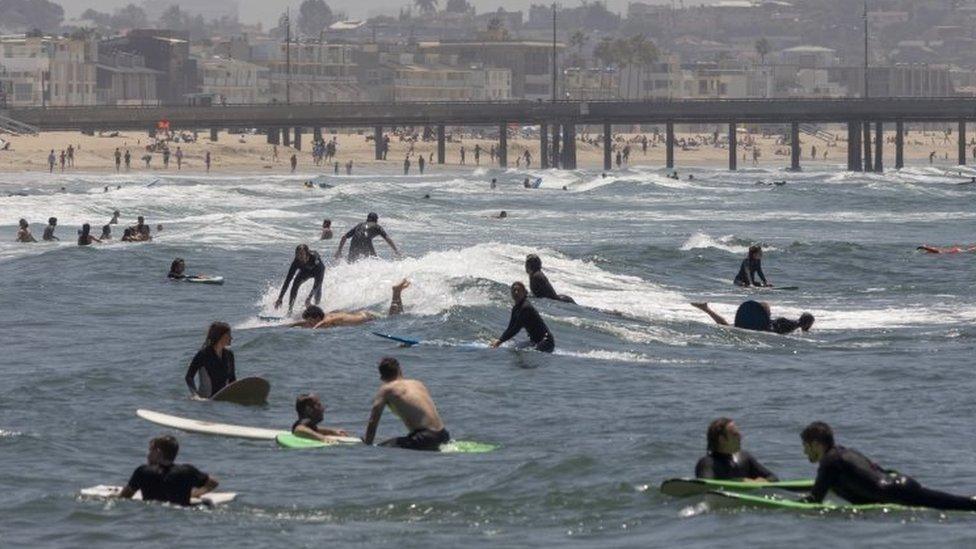 Surfers and beachgoers on Los Angeles' Venice Beach, California. Photo: 24 May 2020