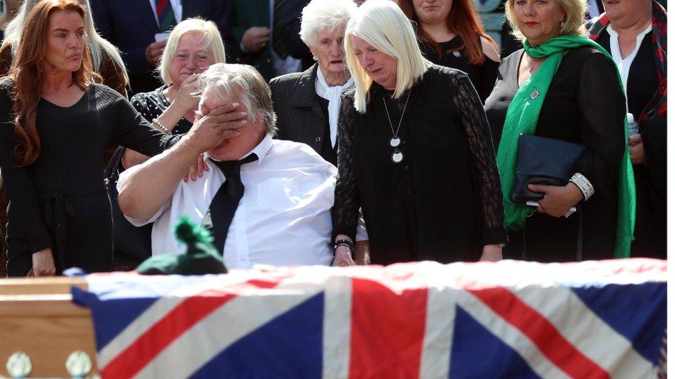 Brett Savage's parents, pictured at his funeral on Friday, say they are "utterly heartbroken"