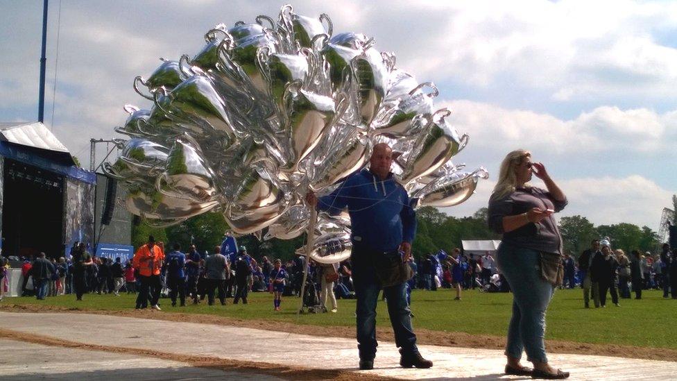 Man selling trophy balloons