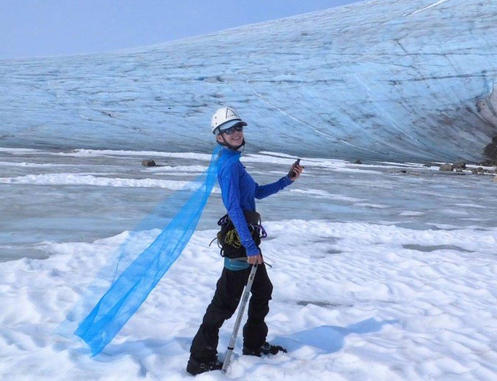 Celeste Labedz wearing a cape in front of a glacier