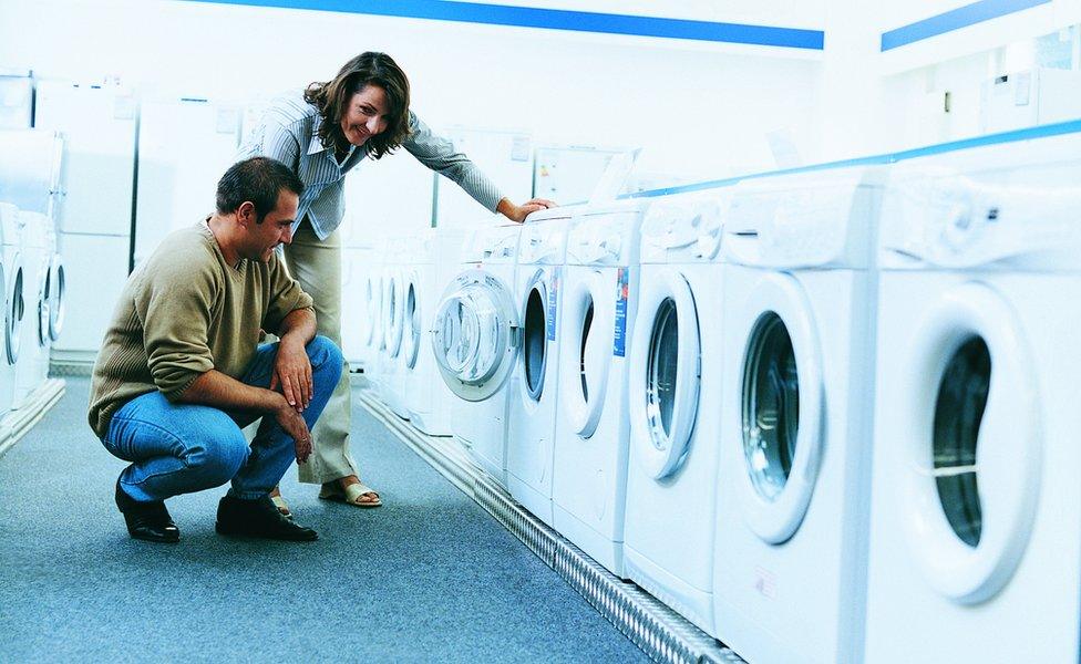 couple looking at washing machines