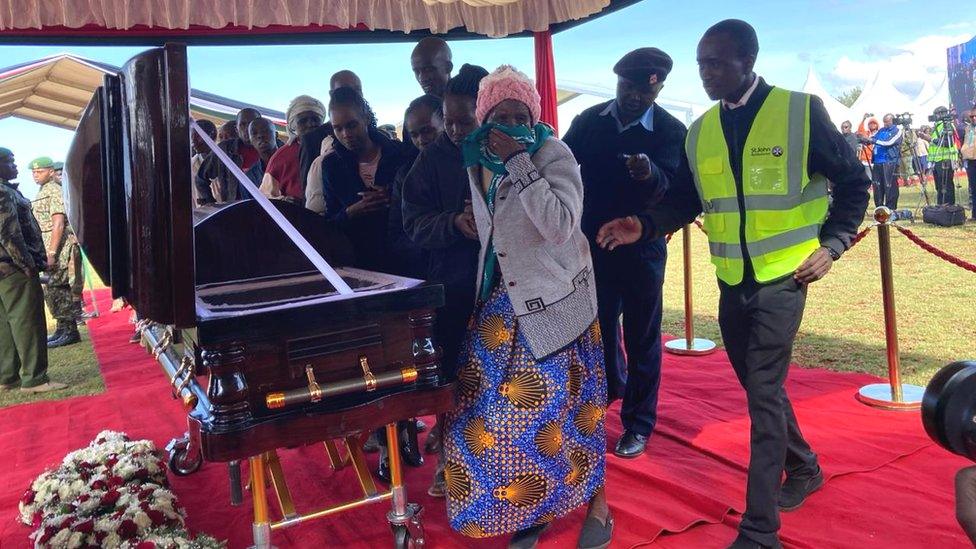 Mourners viewing the body