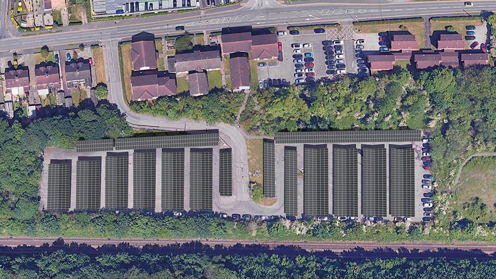 An aerial artist's impression of the new solar carports showing rows of panels surrounded by a railway line and trees
