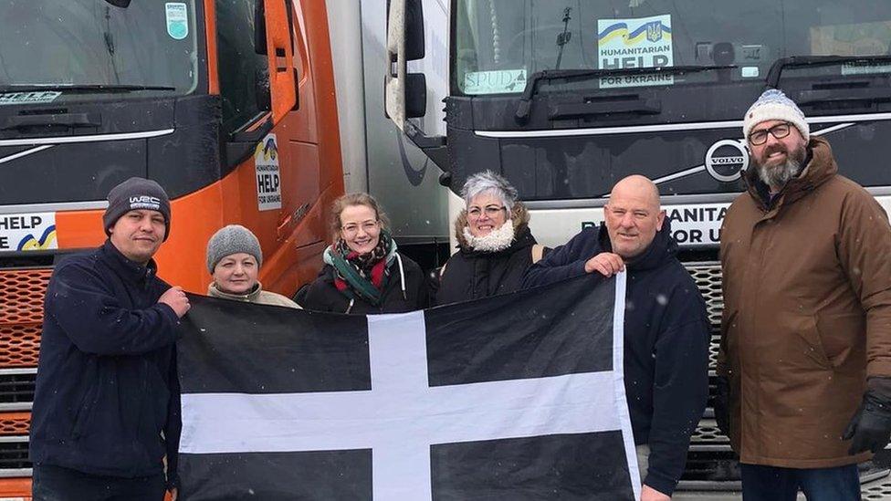 Truck drivers holding the Cornish flag