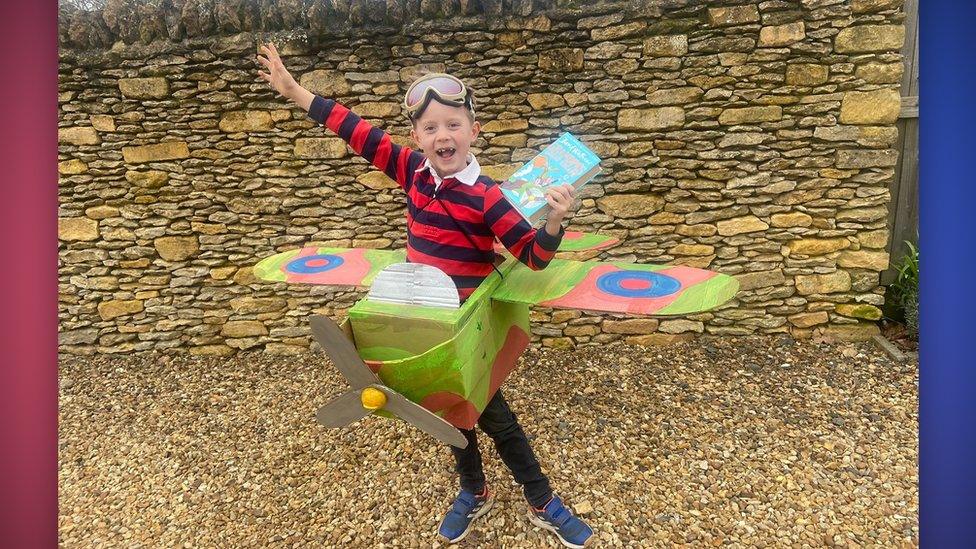 kid dressed up with an aeroplane