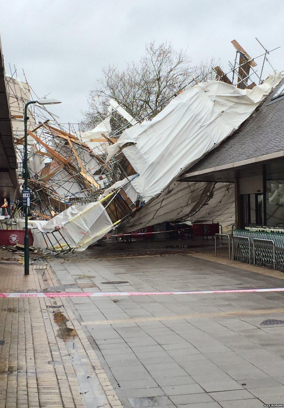 The main shopping street in Woodley, Reading. Alex Morgan says: "The scaffolding from the building on the left has been ripped off and now covers the high street". Credit: Alex Morgan